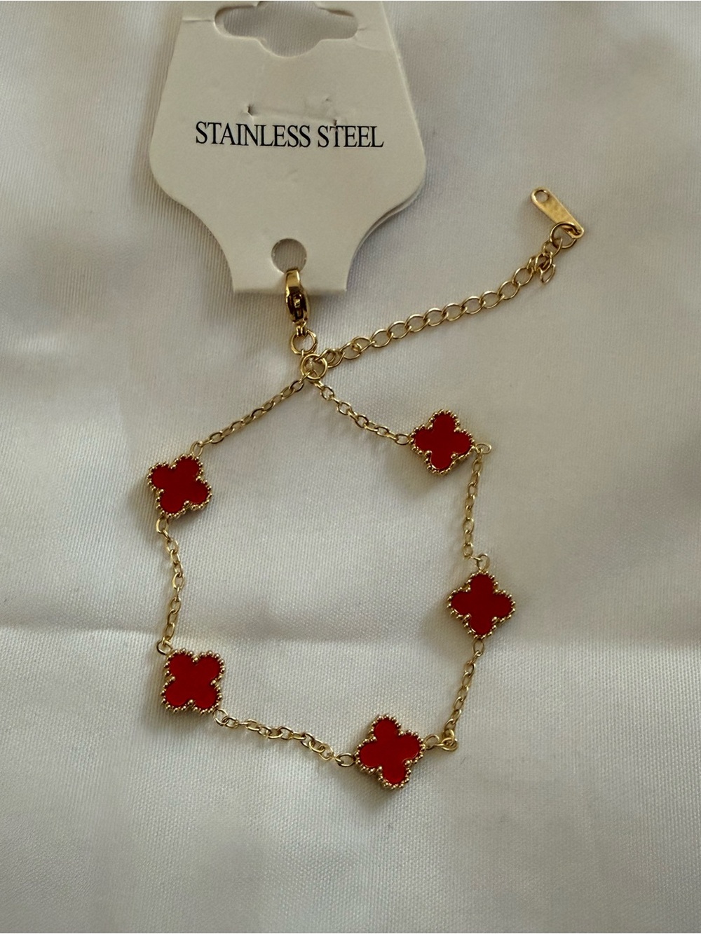 Gold Stainless Steel Bracelet with Red Clover Accents